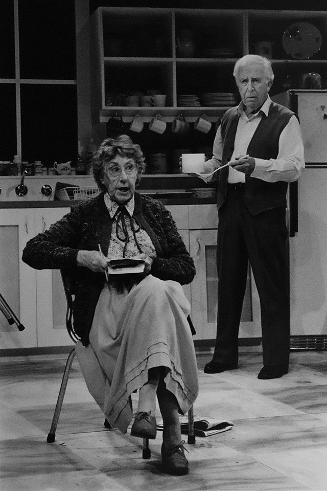 Production still for "Alive and Kicking". L-R: Patricia Kennedy as Rebecca, Brian James as Stan. Photographer: Unknown