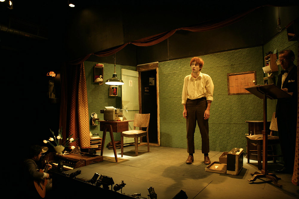 Production still from "The Black Swan of Trespass". L-R: Chris Kohn (on guitar), Christopher Brown, Gavan O'Leary. Photographer: Jeff Busby