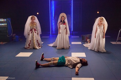 Production still for "The Good Person of Szechuan". L-R: Genevieve Morris, Emily Milledge, Richard Pyros (lying), Genevieve Giuffre. Photographer: Pia Johnson
